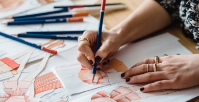 crop woman sketching on paper